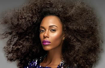 An Afro-American woman with long curly hair.