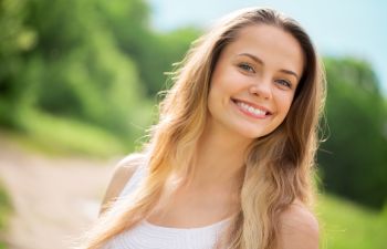 Happy young woman with long blond hair.