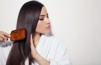 A woman brushing her long dark hair.