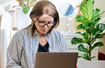 A middle-aged woman with laptop