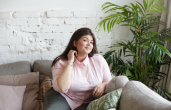 plus size charming young woman with long black hair having mysterious playful look