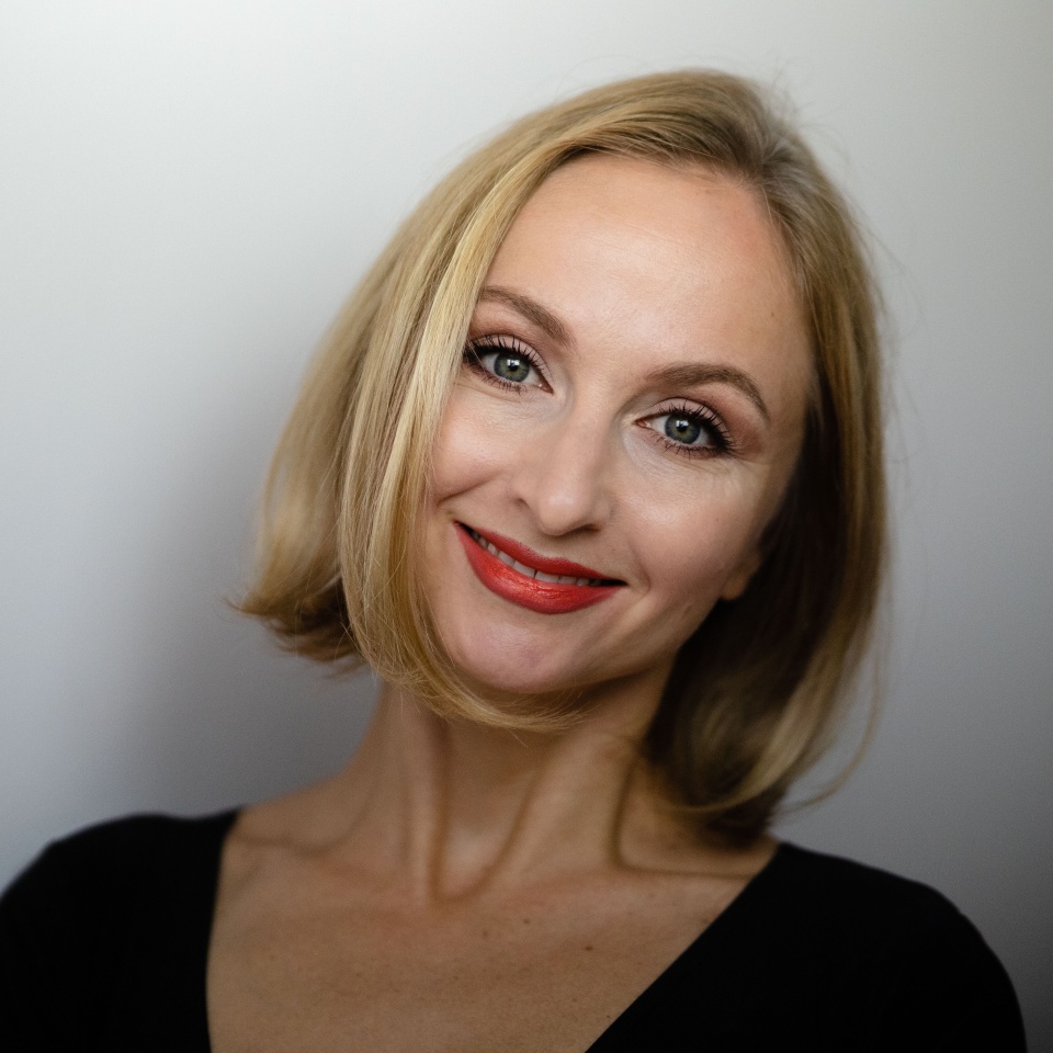 female portrait of a middle-aged European blond woman with a smile on her face and a kind look