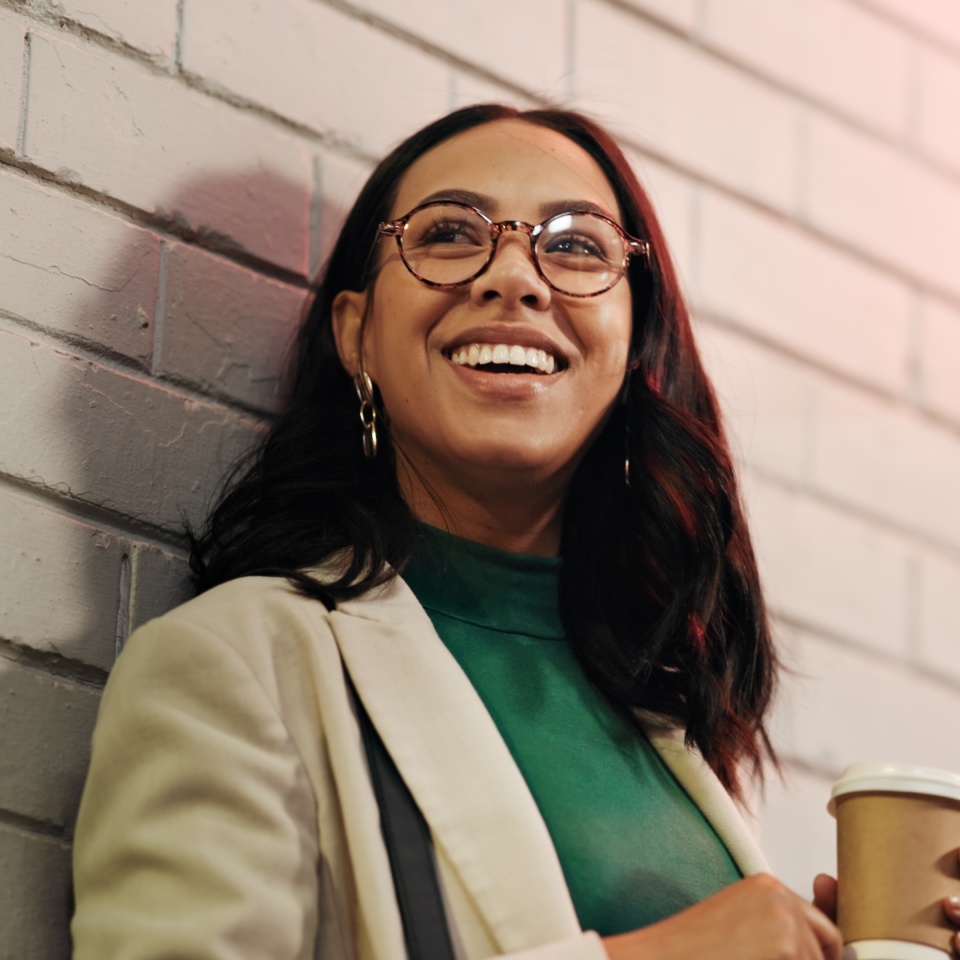 Happy woman, night and thinking with coffee in city for schedule date or waiting for rendezvous. Thoughtful, female person or smile with cup in late evening for outdoor event or club in an urban town