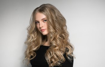 Blonde Woman Beautiful Portrait. Cosmetic concept, platinum Blond Curly Hair Model Girl. Studio shot.